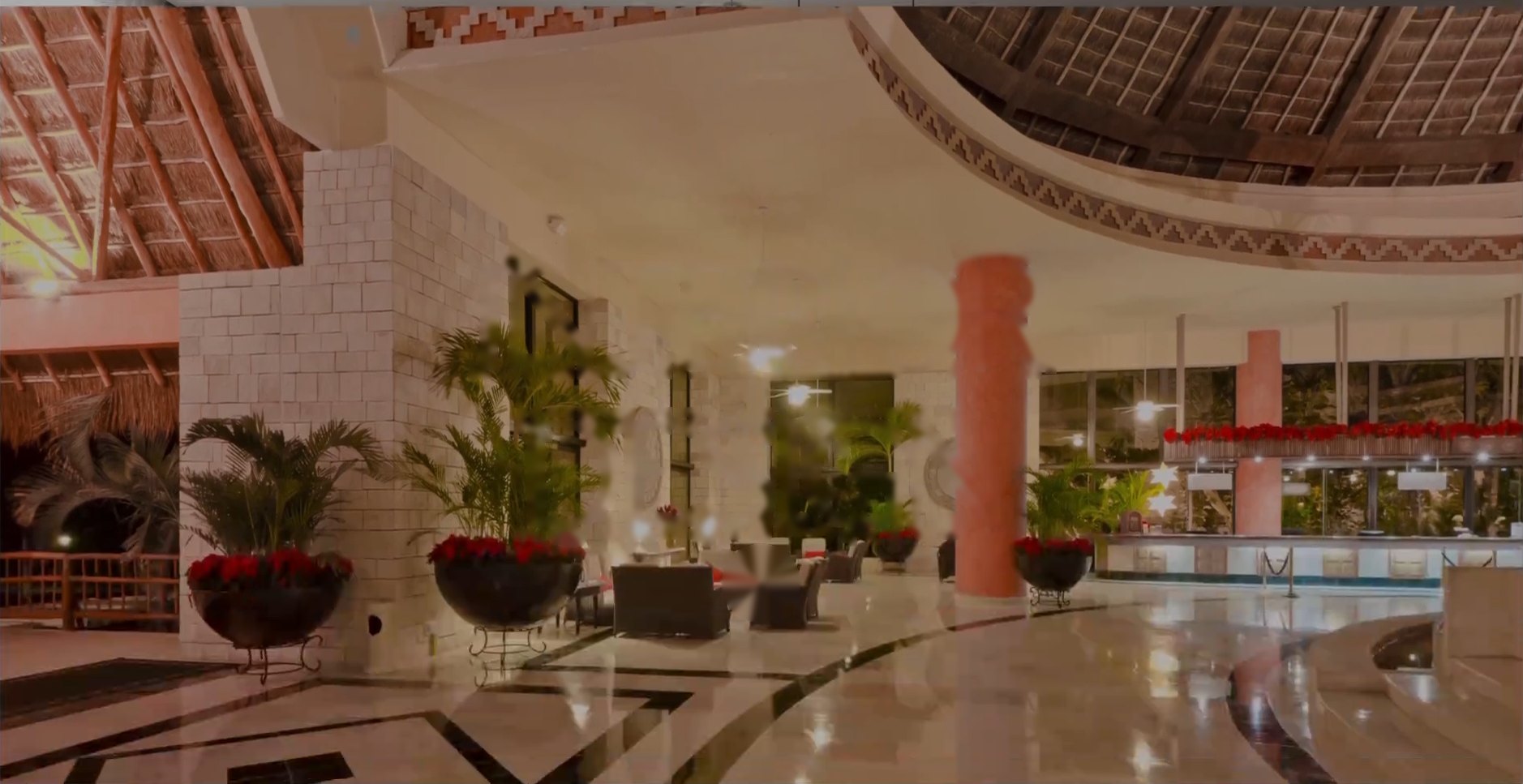 Grand hotel atrium with a thatched dome, marble floors and planted urns