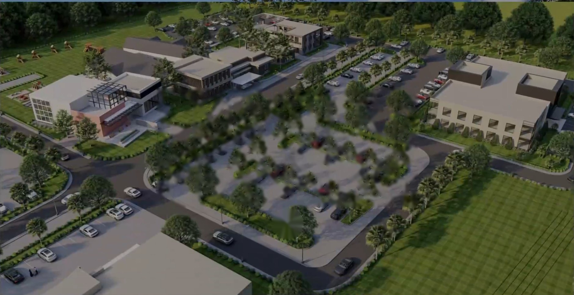 Aerial view of a landscaped campus development with tree-lined parking courts