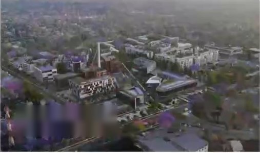 Aerial view of a city precinct framed by jacaranda trees